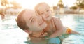 Mom and little daughter are played in the open swimming pool. Family with one child on vacation in warm countries. Positive people Royalty Free Stock Photo