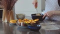 Mom and little daughter are preparing dough together in a bowl in the kitchen. Happy family preparing pie cake Royalty Free Stock Photo