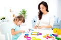 Mom and little daughter sculpt new house of plasticine. Child development and education. Family leisure with a child. Happy