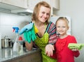 Mom and little girl cleaning at kitchen Royalty Free Stock Photo