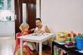 Mom with a little girl sculpt plasticine sitting at a table in the room