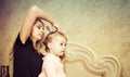 Mom makes a beautiful hairstyle to her daughter Royalty Free Stock Photo