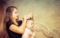 Mom makes a beautiful hairstyle to her daughter Royalty Free Stock Photo