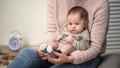 Mom massaging babys feet, method for calming fussy newborn, flatfoot prevention Royalty Free Stock Photo