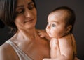 Mom, mummy, young mother with little baby daughter. Breast-feeding. Mum kissing,hugging child. Newborn cute happy girl Royalty Free Stock Photo