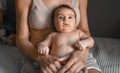 Mom, mummy, young mother with little baby daughter. Breast-feeding. Mum kissing,hugging child. Newborn cute happy girl Royalty Free Stock Photo