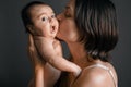 Mom, mummy, young mother with little baby daughter. Breast-feeding. Mum kissing,hugging child. Newborn cute happy girl Royalty Free Stock Photo