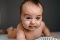 Little baby daughter on bed. One month age. Newborn cute happy beautiful girl smiling. Breast-feeding. Happiness for Royalty Free Stock Photo