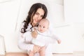 Mom with a newborn baby in her arms at home, the concept of a happy loving family, mother`s day Royalty Free Stock Photo