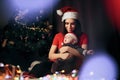 Happy Mother and Baby Sitting Under the Christmas Tree Royalty Free Stock Photo