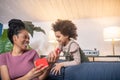 Mom opening gift and joyful little girl Royalty Free Stock Photo