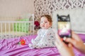 Mom photographs the child, as a keepsake. Mother photographer photographing of her baby on camera Royalty Free Stock Photo