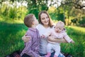 Mom on picnic with eldest son and young daughter. Motherhood and childhood concept