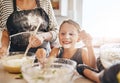 Mom, playing or happy girl baking in kitchen as a happy family with a playful young kid with flour at home. Dirty, messy Royalty Free Stock Photo