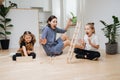 Mom and children watching toy tower collapse emotionally Royalty Free Stock Photo