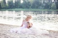 Mom plays with her child on a vacation by the lake. Family lifestyle and love concept. Mother and daughter having tender moments o Royalty Free Stock Photo