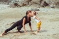 Mom plays with her daughter in the sand Royalty Free Stock Photo