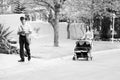 Mom with pram and Mailman delivering mail in a wealthy suburban Royalty Free Stock Photo