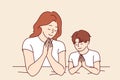 Mom prays with son before bed, asking god to teaching child to religious lifestyle