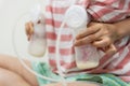 Mom pumping breastmilk into bottles