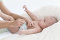 Mom puts on diaper baby changing table Royalty Free Stock Photo