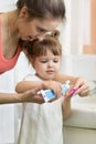 Mother puts toothpaste on a child brush, brushing teeth Royalty Free Stock Photo