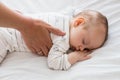 Mom putting baby to sleep in baby bed Royalty Free Stock Photo