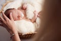 Mom putting baby to sleep in baby bed at home Royalty Free Stock Photo