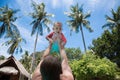 Mom raised the child in swimsuit high above the head in the pool. The little girl is very happy and screams for joy. Summer Royalty Free Stock Photo