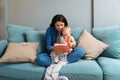 Mom reading a book with baby boy or girl at home. Early age children education, development. Mother and child spending time Royalty Free Stock Photo