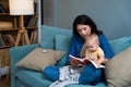 Mom reading a book with baby boy or girl at home. Early age children education, development. Mother and child spending time Royalty Free Stock Photo