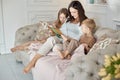 Mom reads a book to the children. A woman tells a story to a boy and a girl before going to bed. Mom daughter and son relax at hom Royalty Free Stock Photo