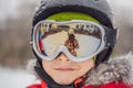 Mom reflected in the boy ski goggles. Mom and Dad teach a boy to ski or snowboard Royalty Free Stock Photo