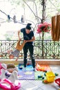 Mom rocks little child upside down on the balcony