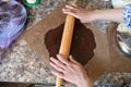 Mom rolls dough. chocolate dough. Hands working with dough preparation recipe bread. Female hands making dough for pizza. Woman`s Royalty Free Stock Photo