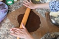 Mom rolls dough. chocolate dough. Hands working with dough preparation recipe bread. Female hands making dough for pizza. Woman`s Royalty Free Stock Photo