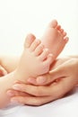 Mom's hands and baby feet. Royalty Free Stock Photo