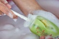 Mom's hands washing baby milk bottle