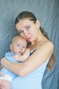 Mom`s love and tenderness. Mother and baby. Happy family. blue-eyed mother holds a child.