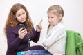 Mom scolding child for viewing inappropriate content on your smartphone Royalty Free Stock Photo