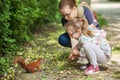 Mom shows daughter a squirrel