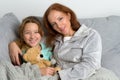 Mom sitting on couch with daughter