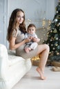 Mom with a small son near a beautiful Christmas tree in his house Royalty Free Stock Photo