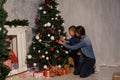 Mom with son adorn the Christmas tree lights Christmas new year Royalty Free Stock Photo