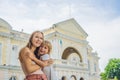 Mom and son on background of Old Town Hall in George Town in Penang, Malaysia. The foundation stone was laid in 1879