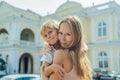 Mom and son on background of Old Town Hall in George Town in Pen