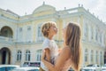 Mom and son on background of Old Town Hall in George Town in Pen