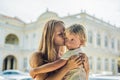 Mom and son on background of Old Town Hall in George Town in Penang, Malaysia. The foundation stone was laid in 1879