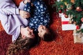 Mom with son at christmas tree with gifts garland winter Royalty Free Stock Photo