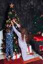 Mom with son at christmas tree with gifts garland winter Royalty Free Stock Photo